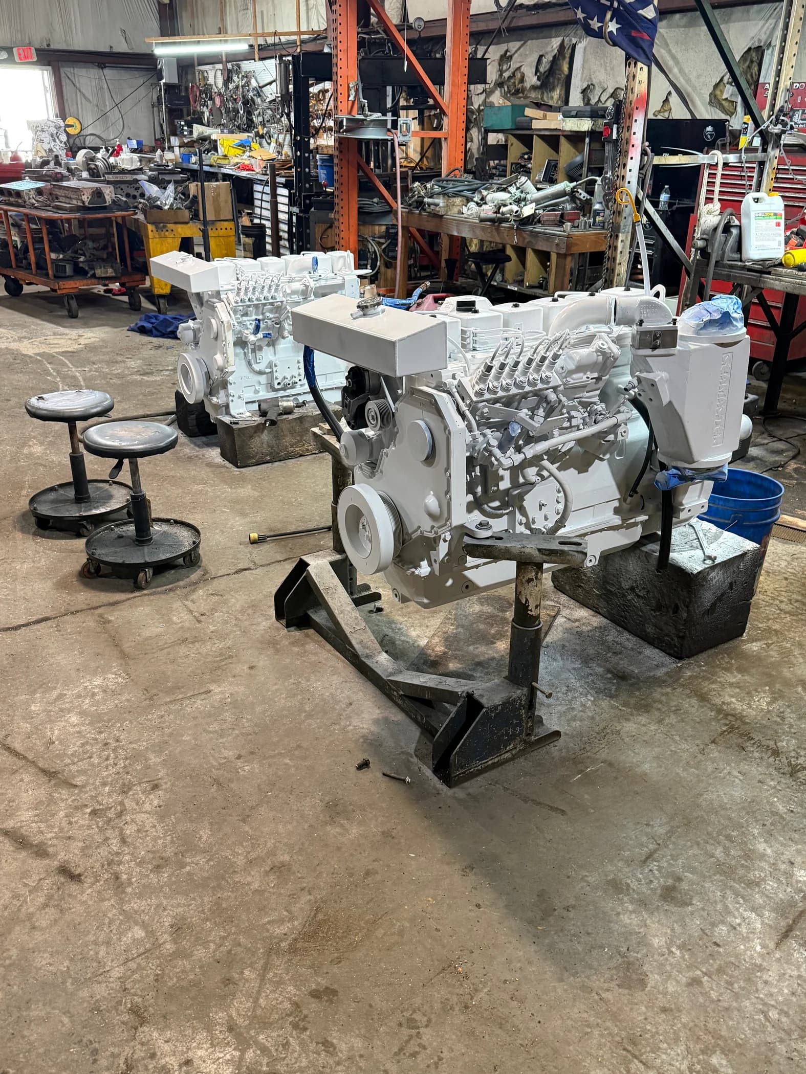 Two white marine diesel engines during rebuild work in the Yachts & Diesels workshop